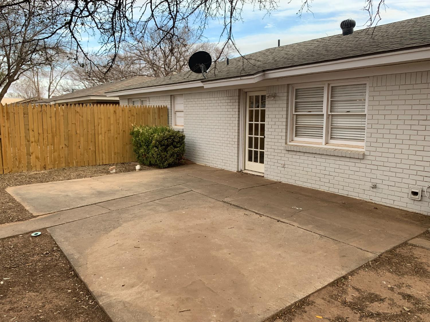 4316 58th Street, Unit B Lubbock, TX 79413 - Photo 4 of 30 a front view of a house with a yard and garage