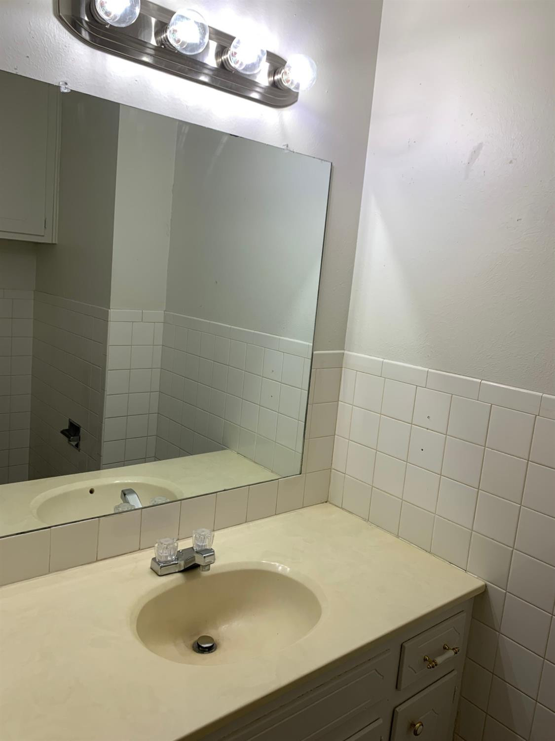 4316 58th Street, Unit B Lubbock, TX 79413 - Photo 6 of 30 a bathroom with a sink and a mirror