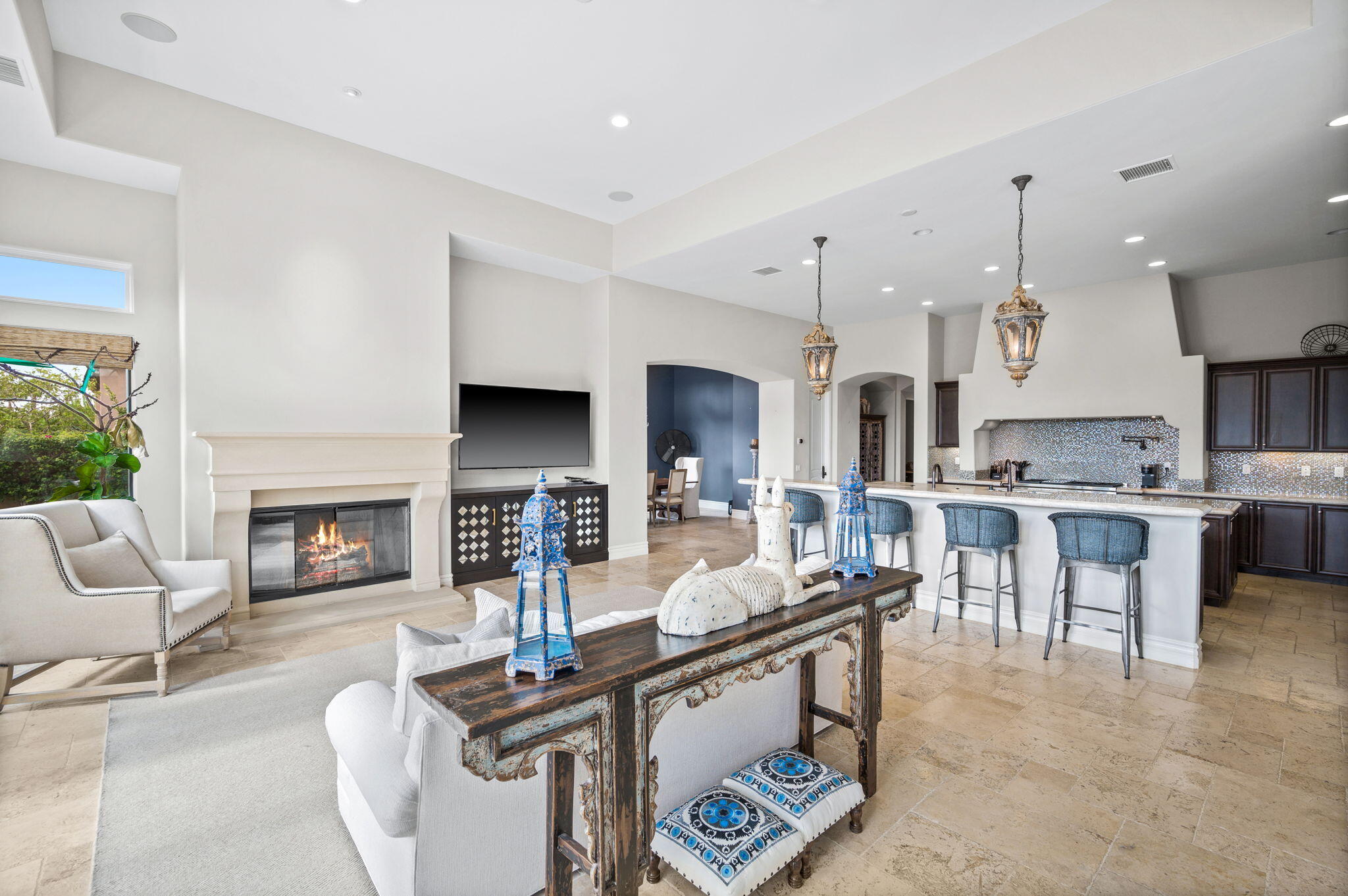 54360 Alysheba Drive La Quinta, CA 92253 - Photo 12 of 68 a living room with furniture a fireplace and kitchen view