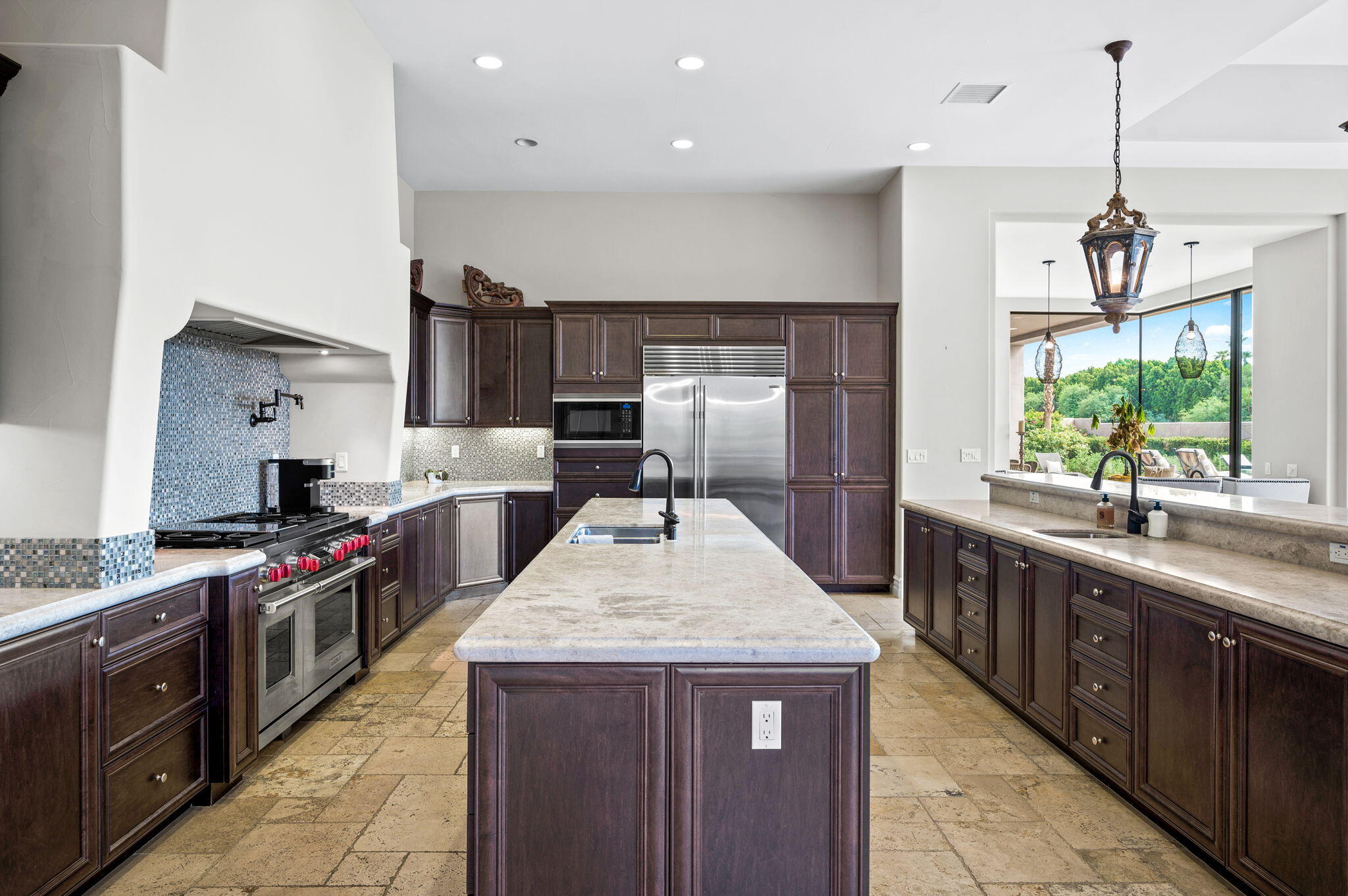 54360 Alysheba Drive La Quinta, CA 92253 - Photo 15 of 68 a kitchen with stainless steel appliances granite countertop wooden cabinets a sink dishwasher a stove and a refrigerator