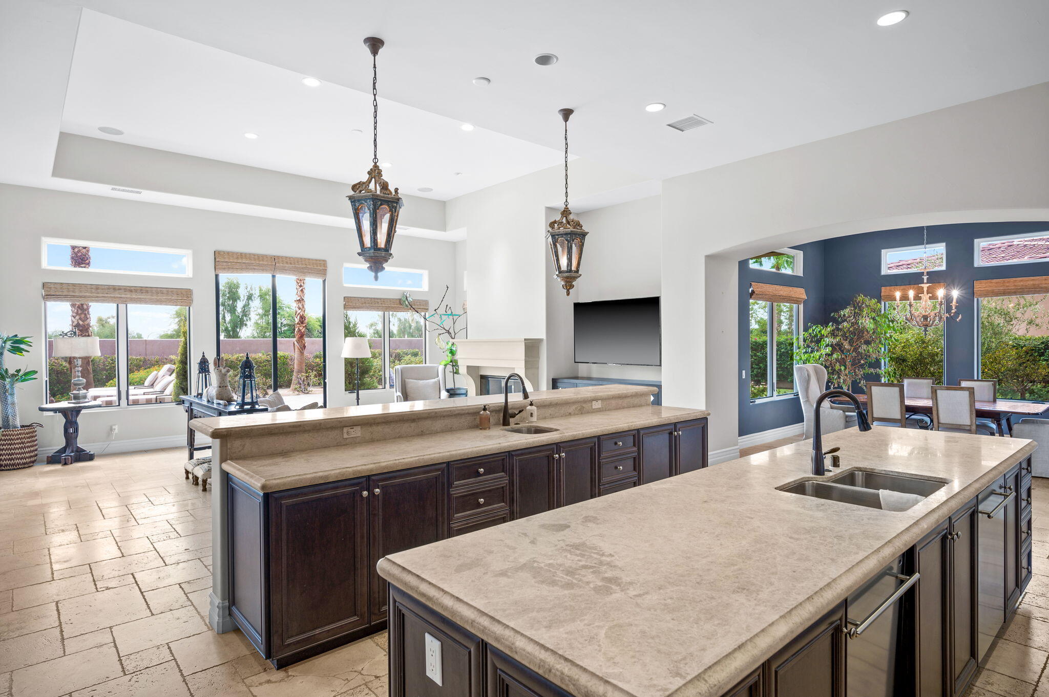 54360 Alysheba Drive La Quinta, CA 92253 - Photo 16 of 68 a kitchen with stainless steel appliances granite countertop a sink a counter space and a center island