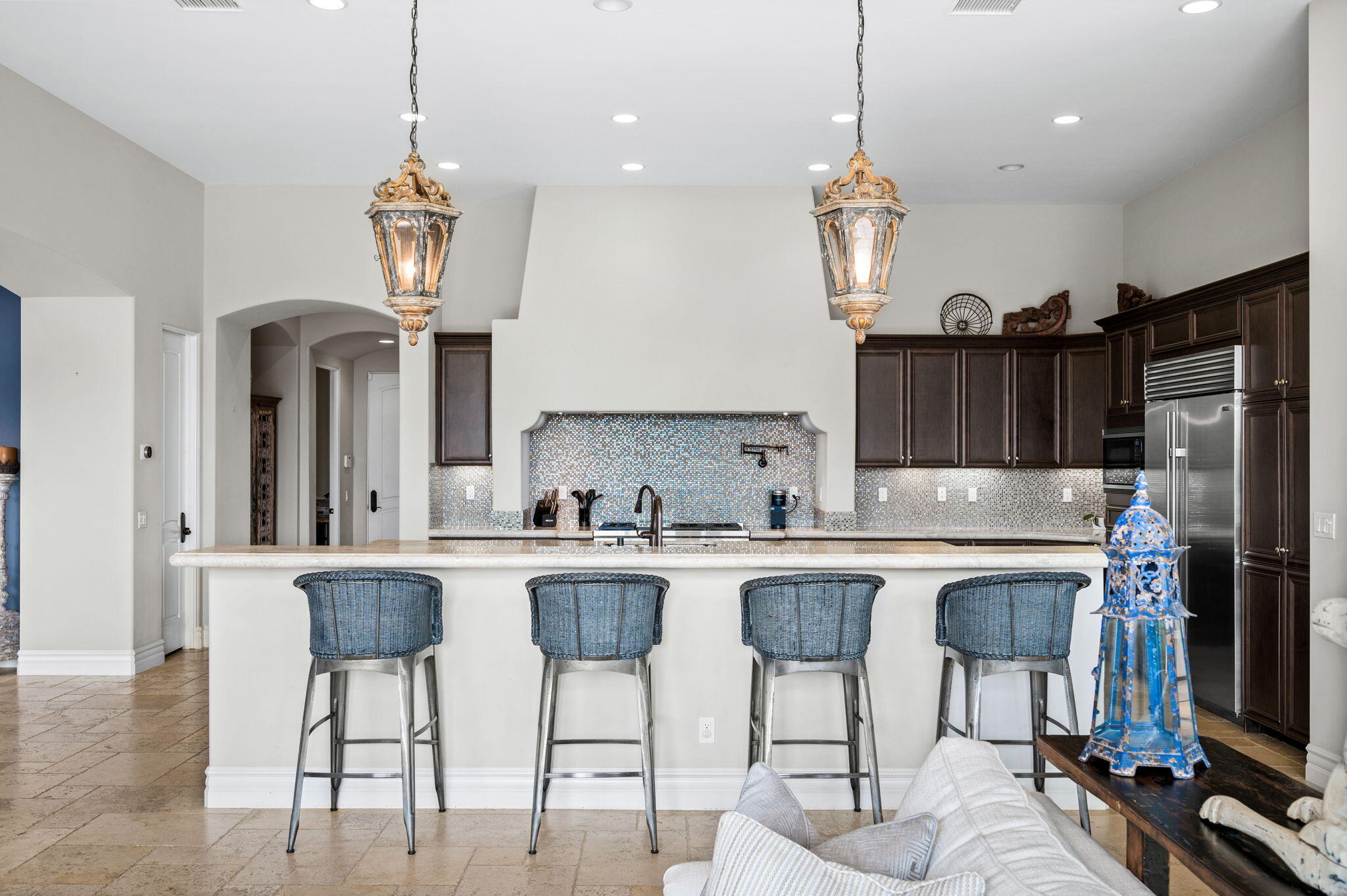 54360 Alysheba Drive La Quinta, CA 92253 - Photo 18 of 68 a kitchen with stainless steel appliances granite countertop a sink a stove a refrigerator cabinets and dining table