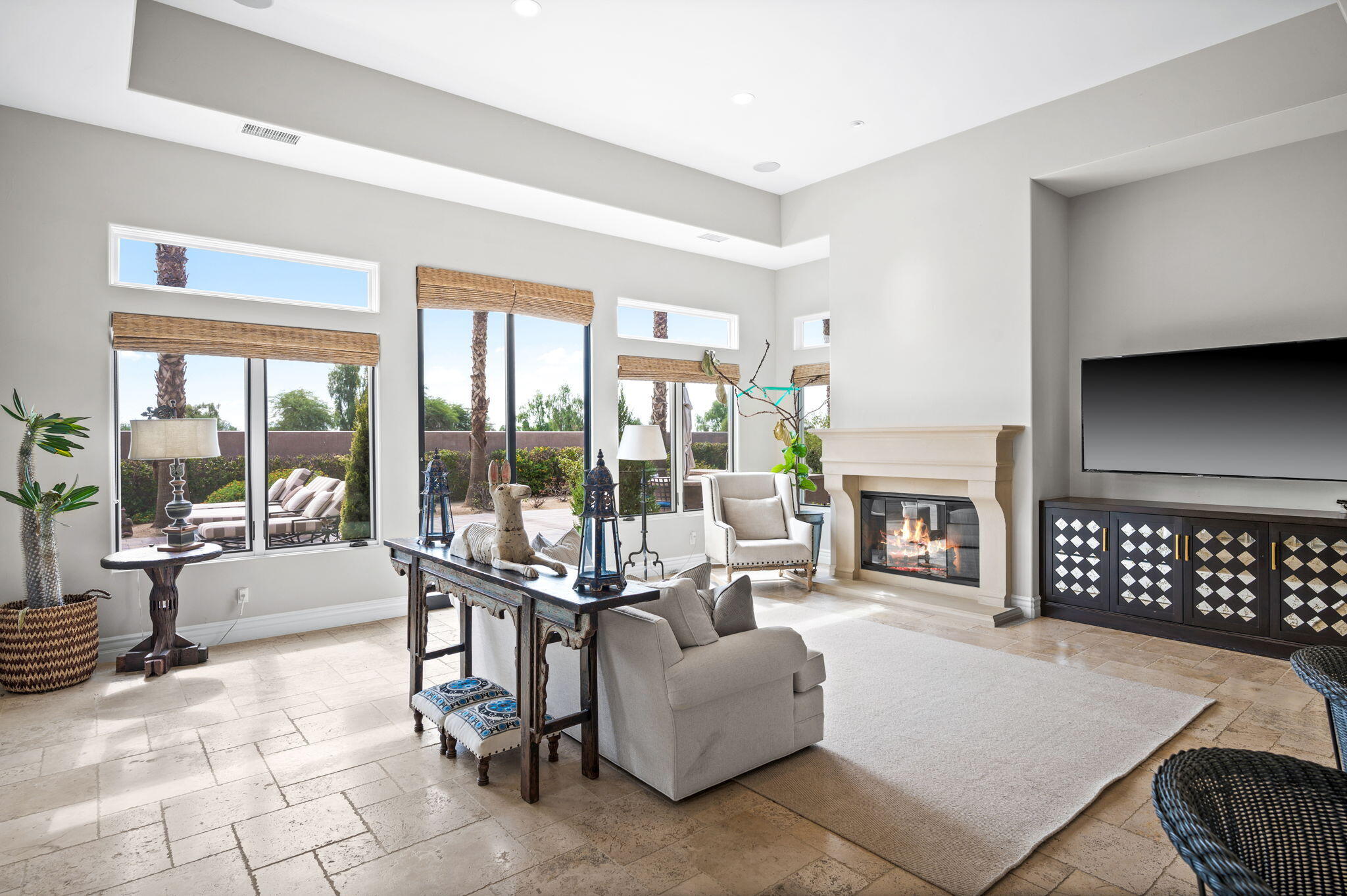 54360 Alysheba Drive La Quinta, CA 92253 - Photo 20 of 68 a living room with furniture a fireplace and a floor to ceiling window
