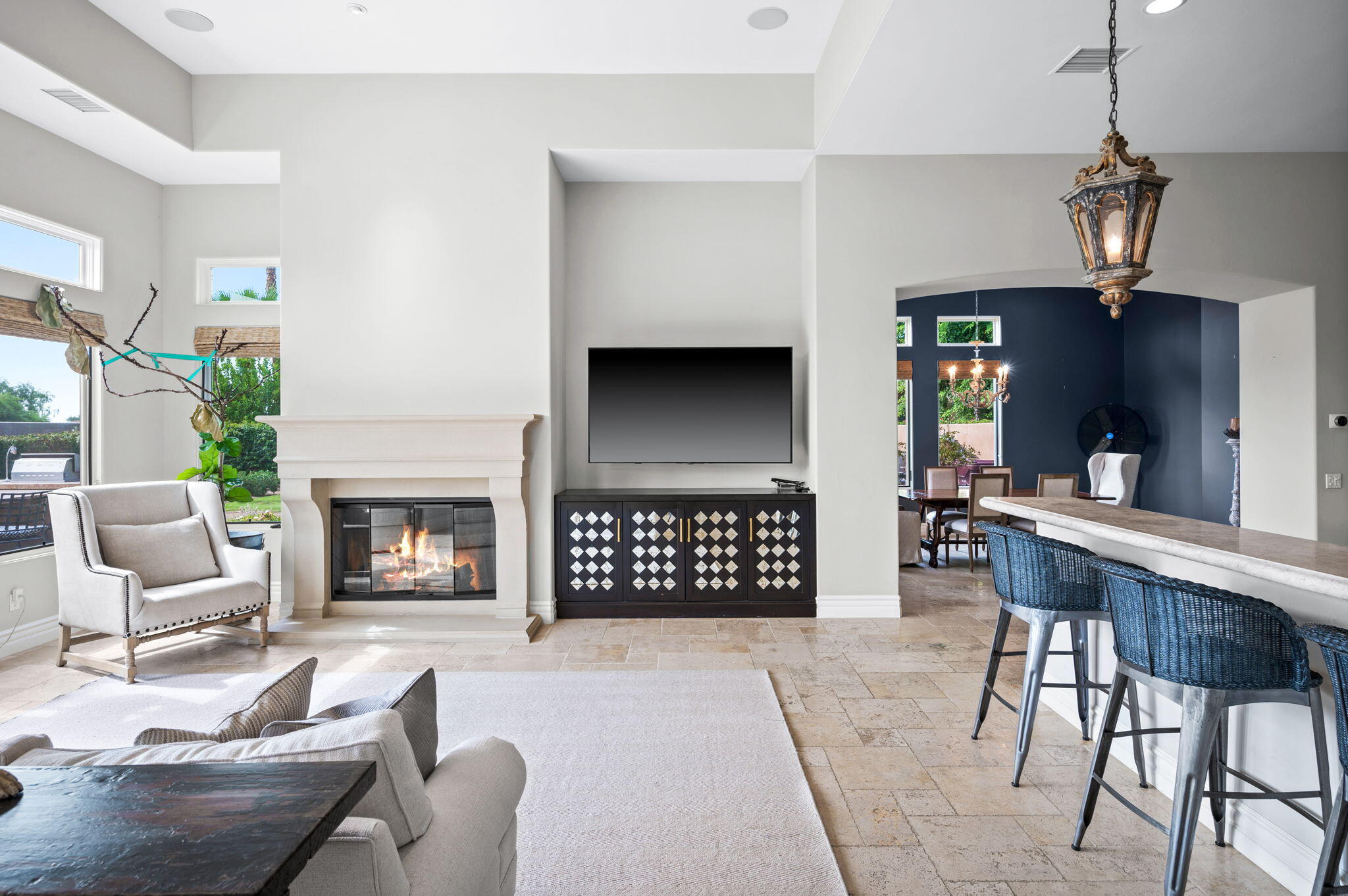 54360 Alysheba Drive La Quinta, CA 92253 - Photo 21 of 68 a living room with furniture a fireplace and a chandelier