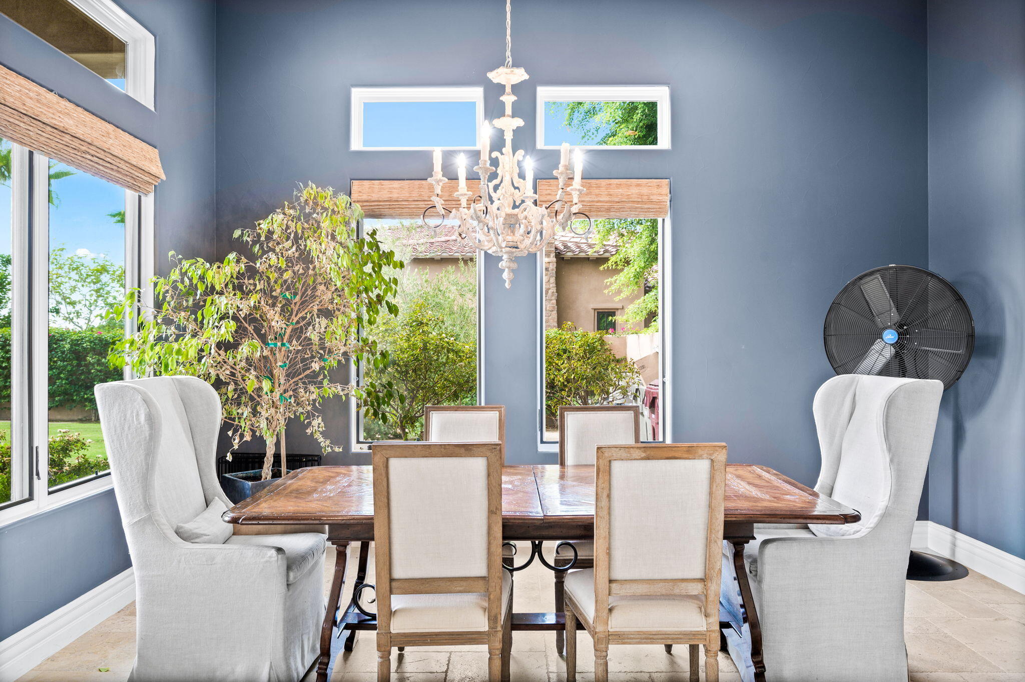 54360 Alysheba Drive La Quinta, CA 92253 - Photo 23 of 68 a dining room with furniture a large window and a chandelier