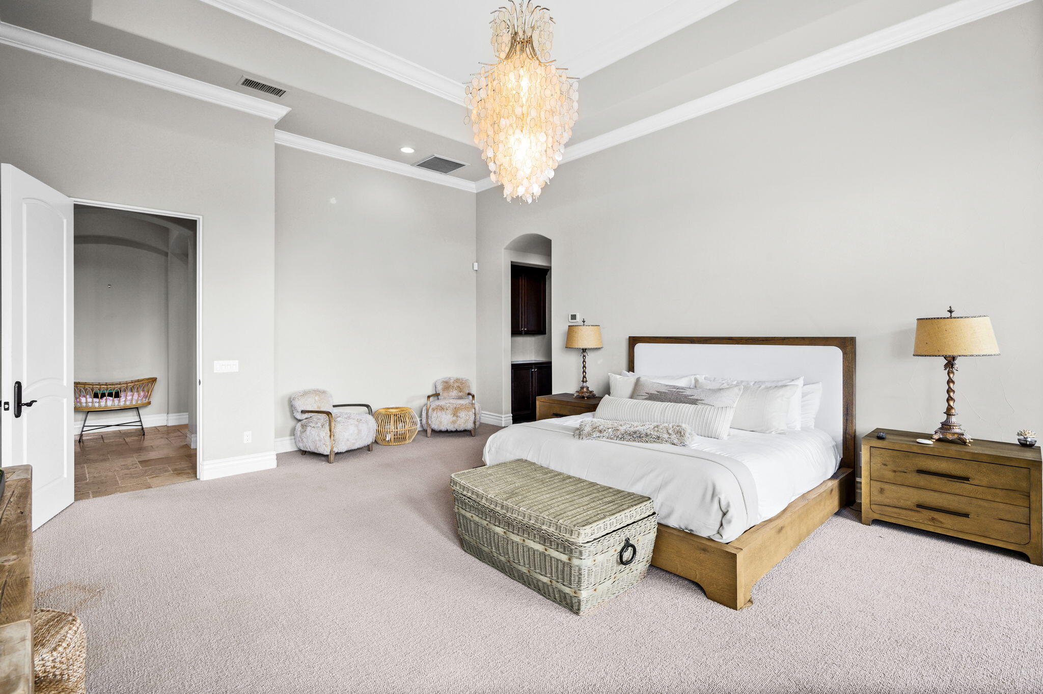 54360 Alysheba Drive La Quinta, CA 92253 - Photo 28 of 68 a bedroom with bed and a chandelier