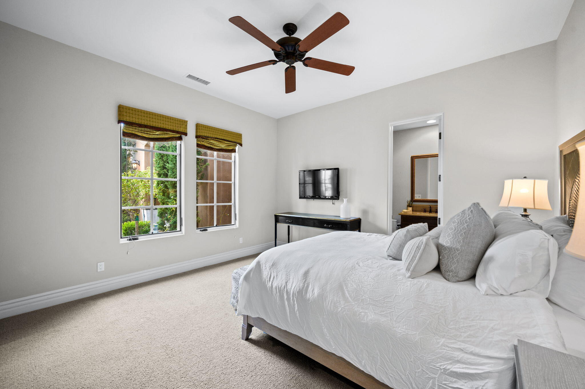54360 Alysheba Drive La Quinta, CA 92253 - Photo 35 of 68 a bedroom with a large bed and a large window
