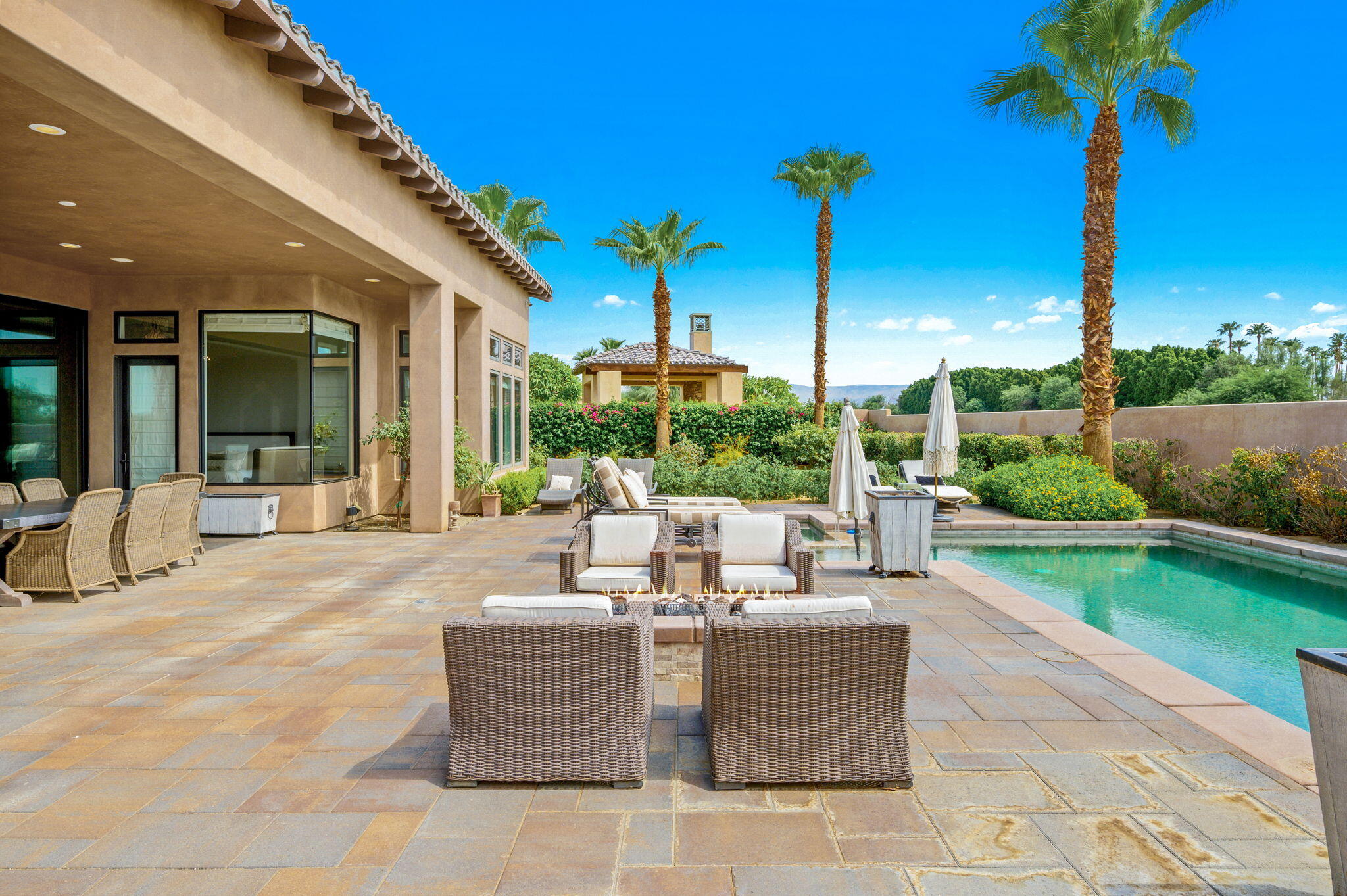 54360 Alysheba Drive La Quinta, CA 92253 - Photo 51 of 68 a view of a patio with a table chairs and a fire pit