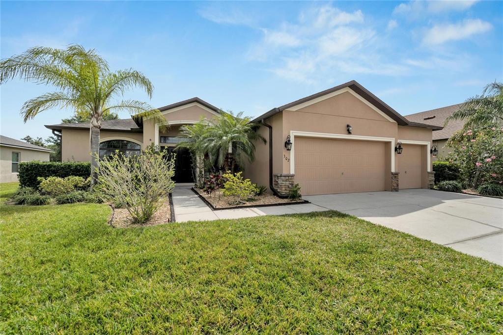 302 Star Shell Drive Apollo Beach, FL 33572 - Photo 1 of 1 a front view of a house with a yard and garage