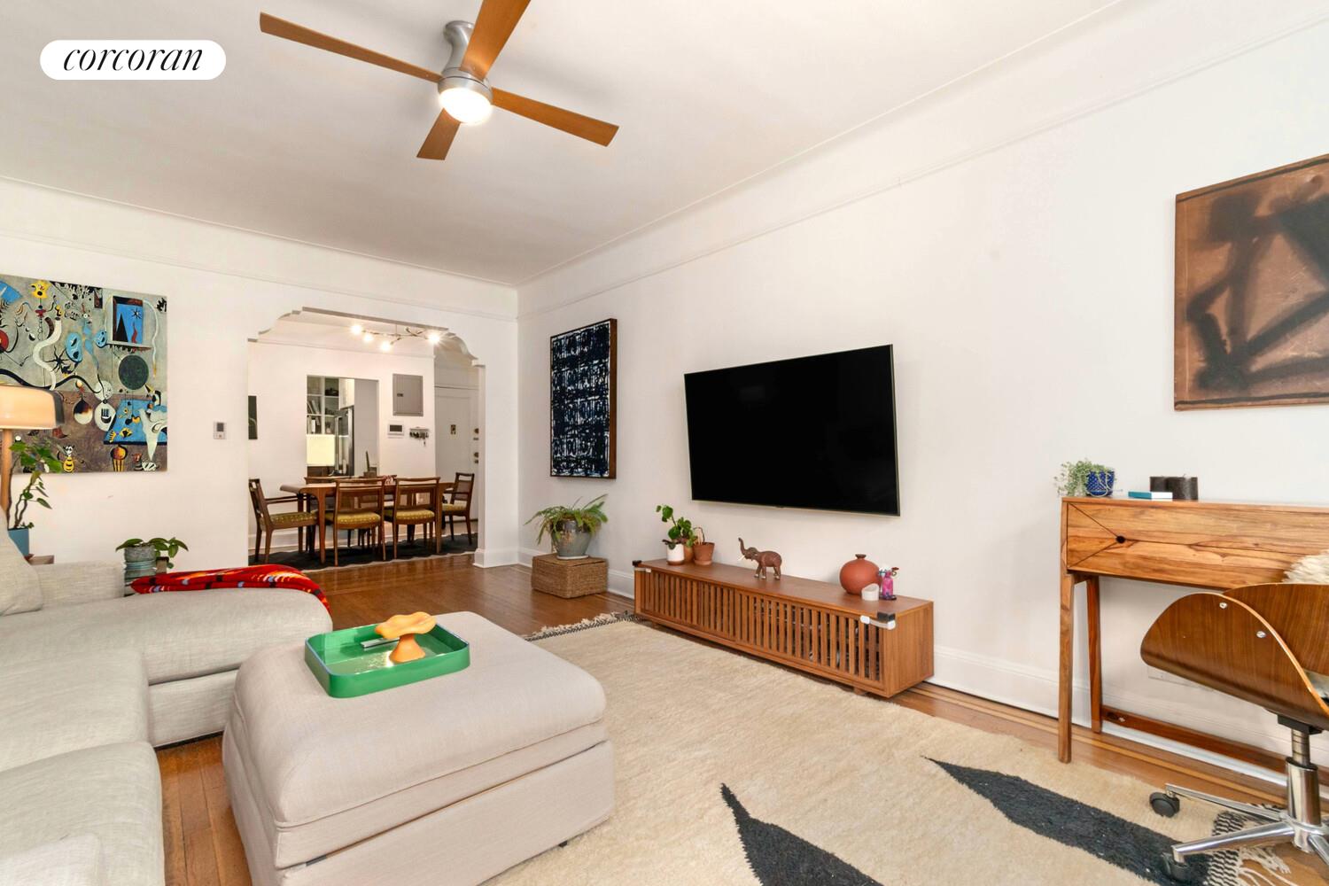 35-53 77th Street, Unit 3G Queens, NY 11372 - Photo 2 of 10 a living room with furniture and a flat screen tv