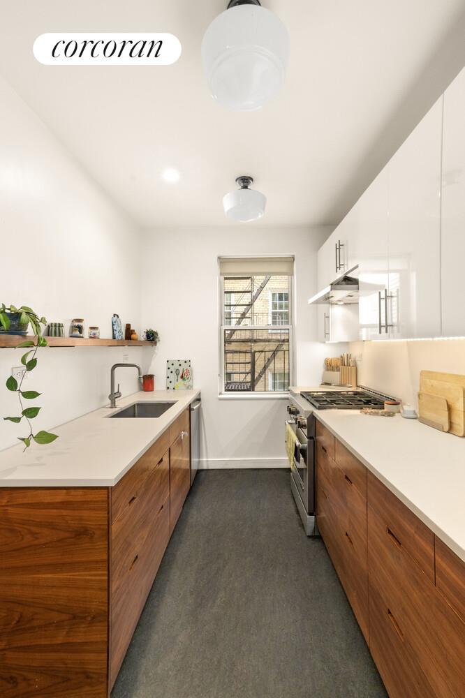 35-53 77th Street, Unit 3G Queens, NY 11372 - Photo 5 of 10 a large kitchen with a stove and a sink