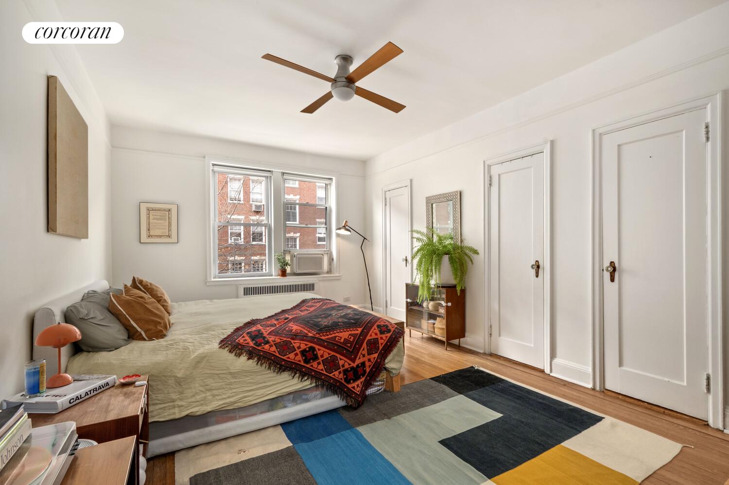 35-53 77th Street, Unit 3G Queens, NY 11372 - Photo 6 of 10 a living room with furniture and a window