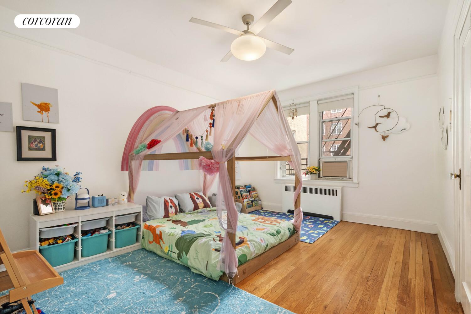 35-53 77th Street, Unit 3G Queens, NY 11372 - Photo 7 of 10 a bedroom with a bed and a wooden floor