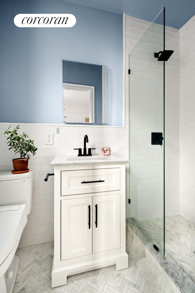 35-53 77th Street, Unit 3G Queens, NY 11372 - Photo 8 of 10 a bathroom with a sink and a mirror