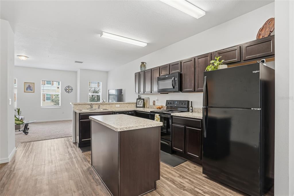5523 Yellowfin Court New Port Richey, FL 34652 - Photo 17 of 58 a kitchen with stainless steel appliances a refrigerator sink and stove