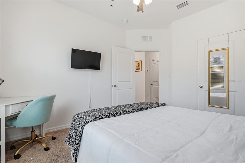 5523 Yellowfin Court New Port Richey, FL 34652 - Photo 31 of 58 a bedroom with a bed tv and chair