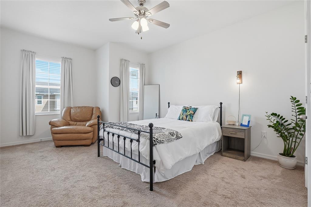 5523 Yellowfin Court New Port Richey, FL 34652 - Photo 36 of 58 a spacious bedroom with a bed and a couch