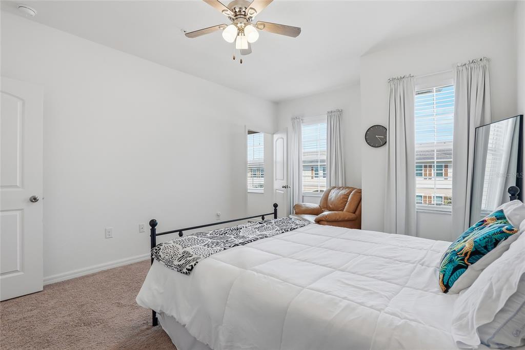 5523 Yellowfin Court New Port Richey, FL 34652 - Photo 38 of 58 a bedroom with a large bed and a chandelier