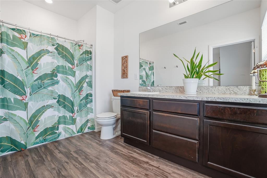 5523 Yellowfin Court New Port Richey, FL 34652 - Photo 39 of 58 a bathroom with a granite countertop sink a toilet and a mirror