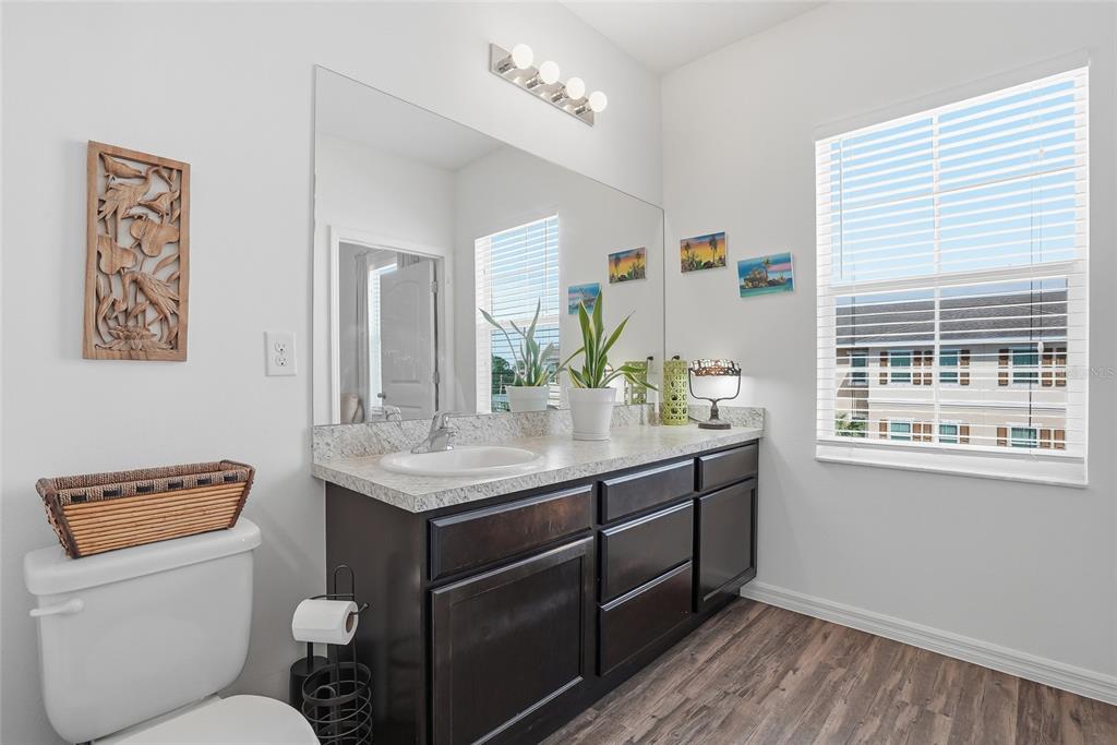 5523 Yellowfin Court New Port Richey, FL 34652 - Photo 41 of 58 a bathroom with a granite countertop sink and a toilet