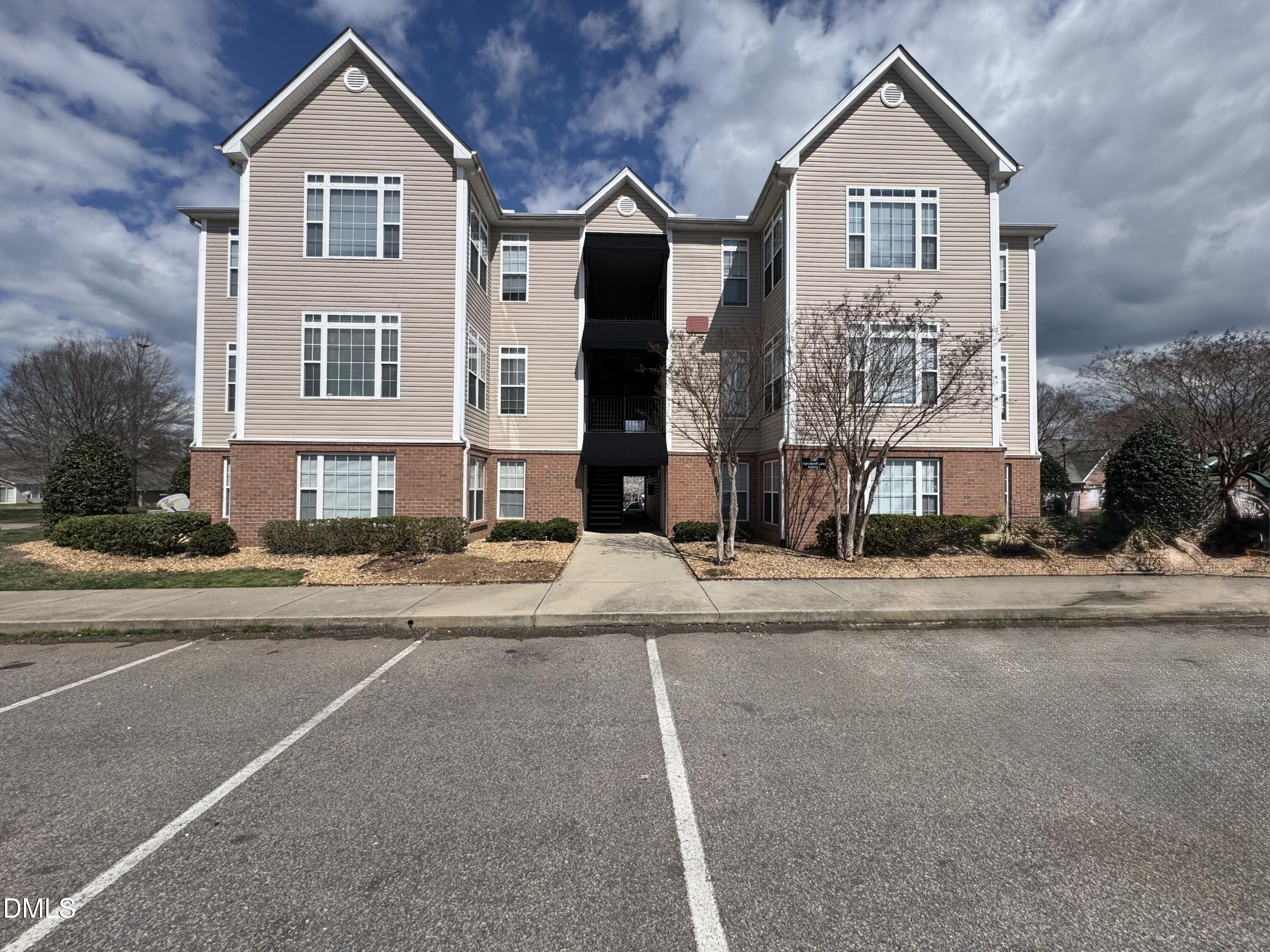 2501 Huntscroft Lane, Unit 201 Raleigh, NC 27617 - Photo 1 of 19 a front view of a house with a yard