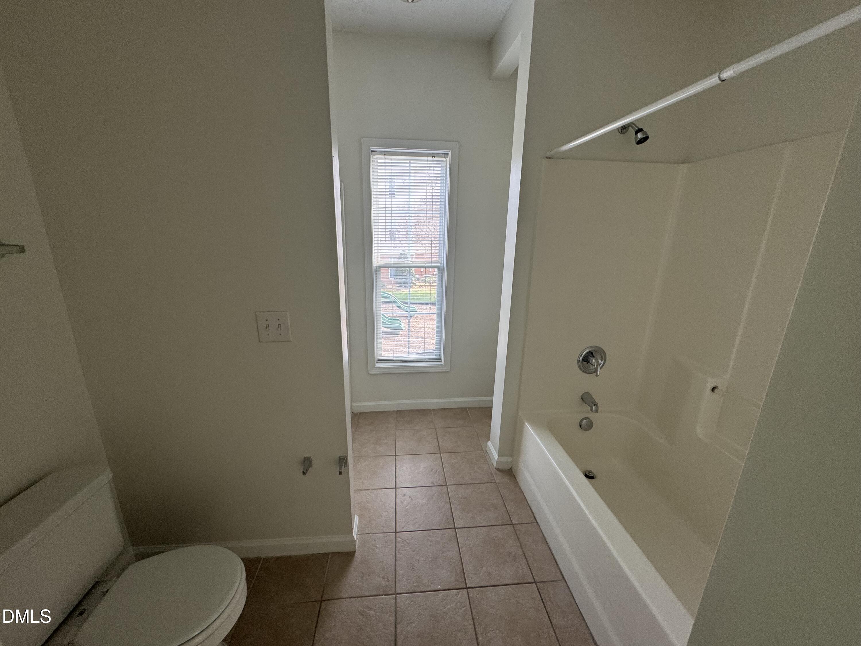 2501 Huntscroft Lane, Unit 201 Raleigh, NC 27617 - Photo 17 of 19 a bathroom with a toilet and a shower