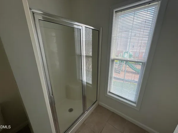 a bathroom with a glass shower door