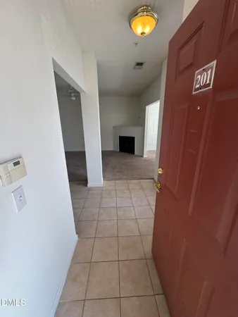 a view of hallway with a window and a fireplace