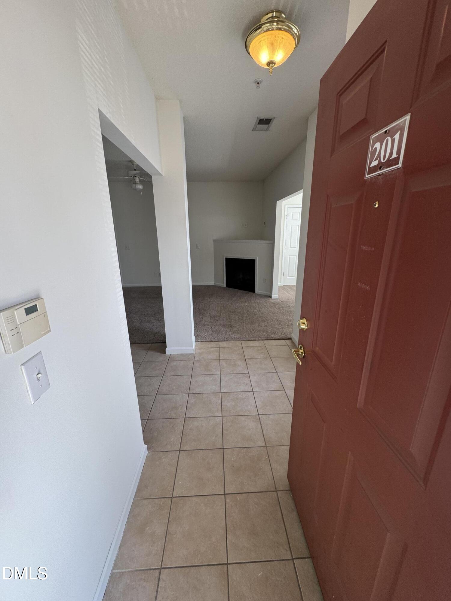 2501 Huntscroft Lane, Unit 201 Raleigh, NC 27617 - Photo 3 of 19 a view of hallway with a window and a fireplace