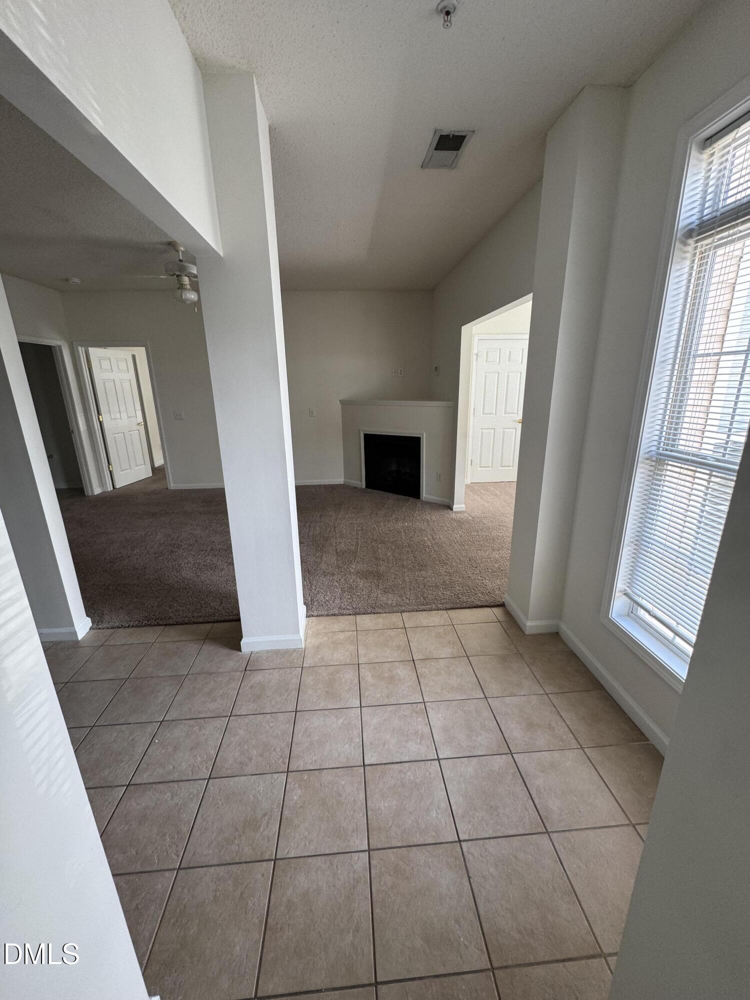 2501 Huntscroft Lane, Unit 201 Raleigh, NC 27617 - Photo 4 of 19 a view of an empty room and a fireplace
