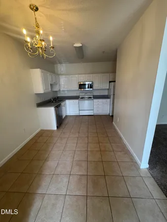 a view of a kitchen with a sink and cabinets