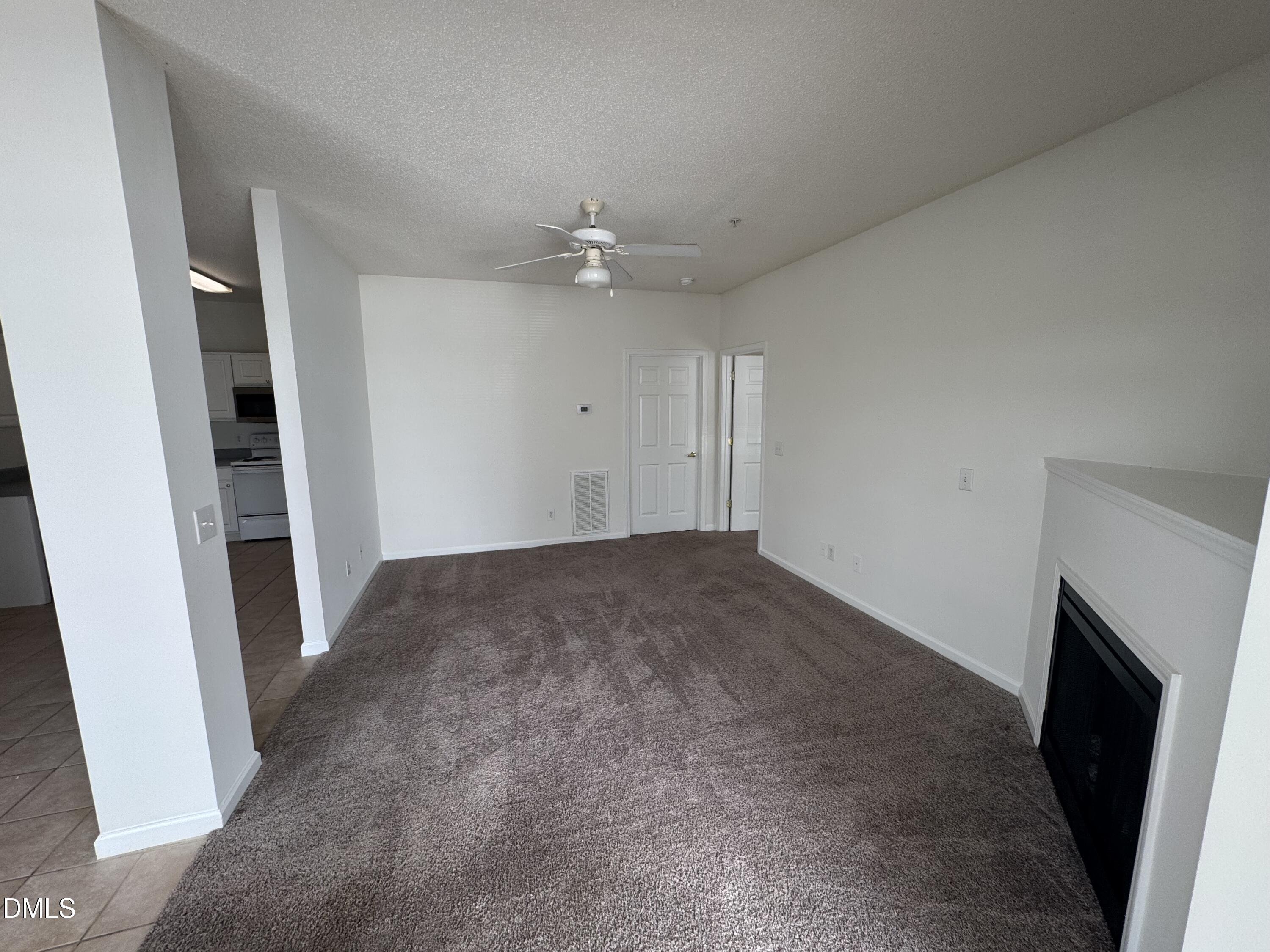 2501 Huntscroft Lane, Unit 201 Raleigh, NC 27617 - Photo 9 of 19 wooden floor in an empty room with a fireplace