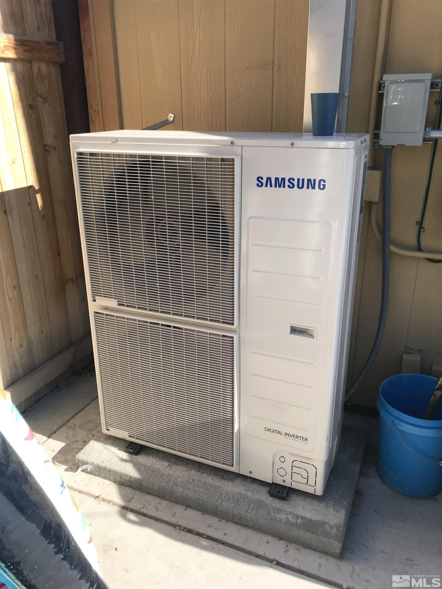 a room with water heater and white cabinets