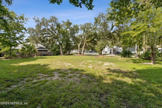 a view of yard with swimming pool and green space