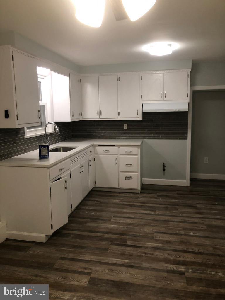 3250 Broad Hamilton, NJ 08610 - Photo 5 of 43 a kitchen with stainless steel appliances granite countertop a sink a stove and white cabinets