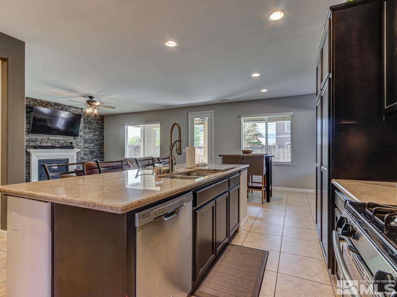 2075 Tawleed Road Reno, NV 89521 - Photo 14 of 24 a kitchen with stainless steel appliances granite countertop a sink stove and refrigerator