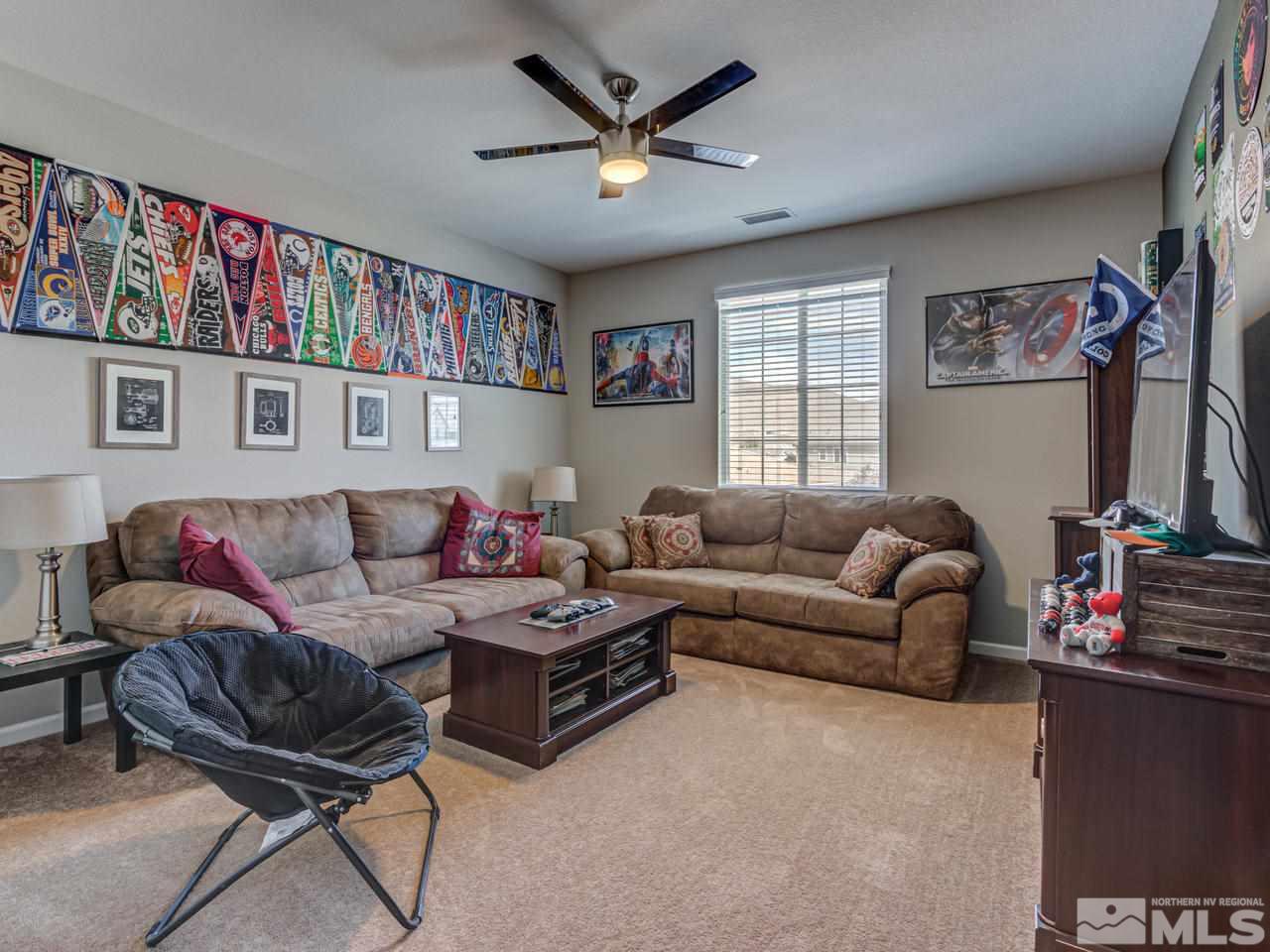 2075 Tawleed Road Reno, NV 89521 - Photo 18 of 24 a living room with furniture and a bookshelf