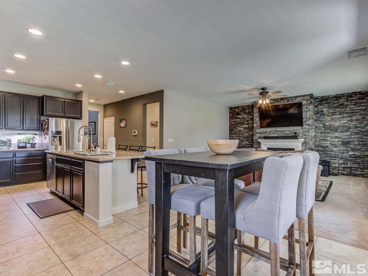 2075 Tawleed Road Reno, NV 89521 - Photo 10 of 24 a kitchen with stainless steel appliances granite countertop a stove top oven a sink a counter space and cabinets