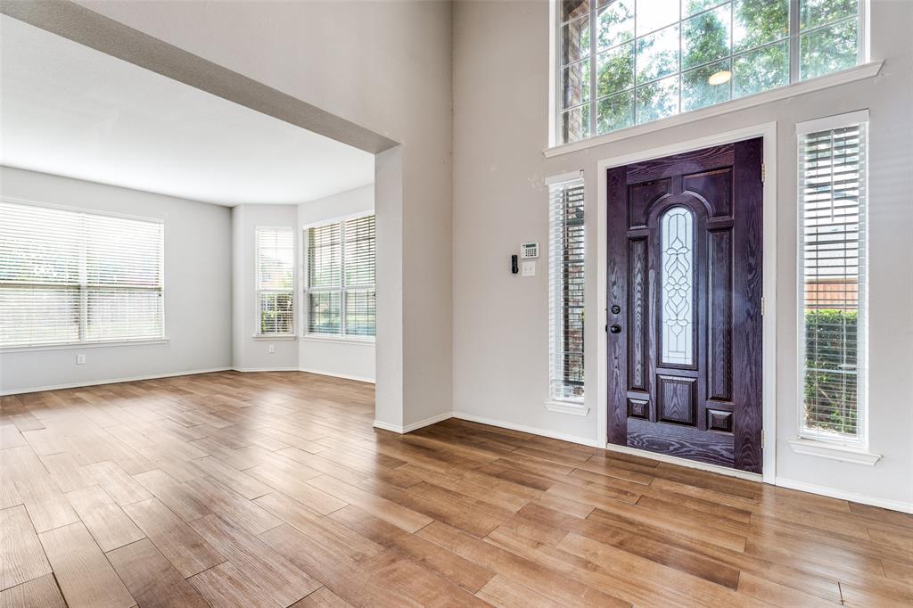 1445 Berkley Road Allen, TX 75002 - Photo 3 of 30 The spacious front entry hall is flanked by flexible space on one side and dining space on the other. Large windows and high ceilings create a light and airy feeling.
