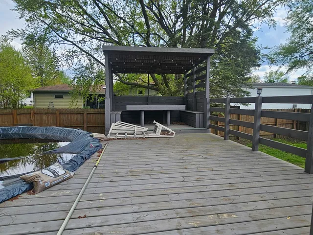 a backyard of a house with plants and brick wall