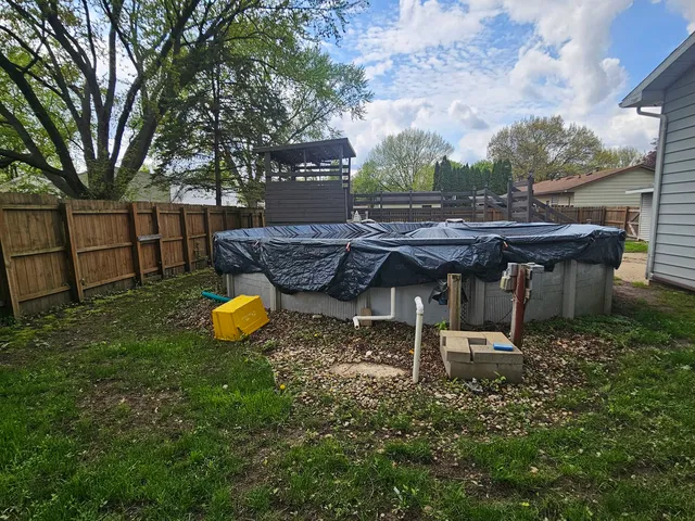 a view of small white building with large trees and stairs