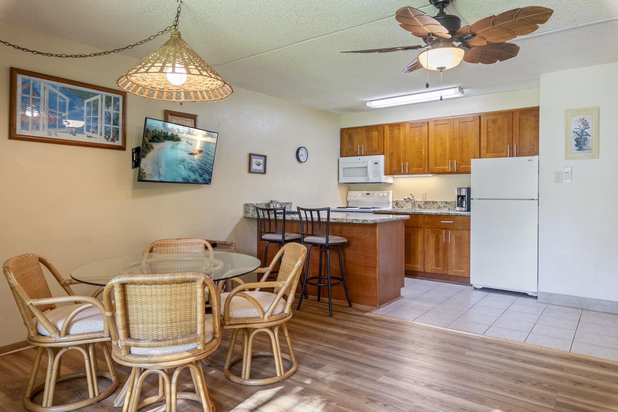 2495 South Kihei Road, Unit 120 Kihei, HI 96753 - Photo 12 of 40 a view of a dining room with furniture and wooden floor