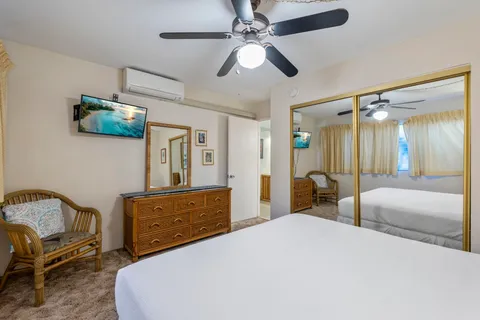 a bedroom with a bed a couch and dresser