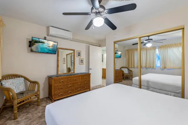 a bedroom with a bed a couch and dresser