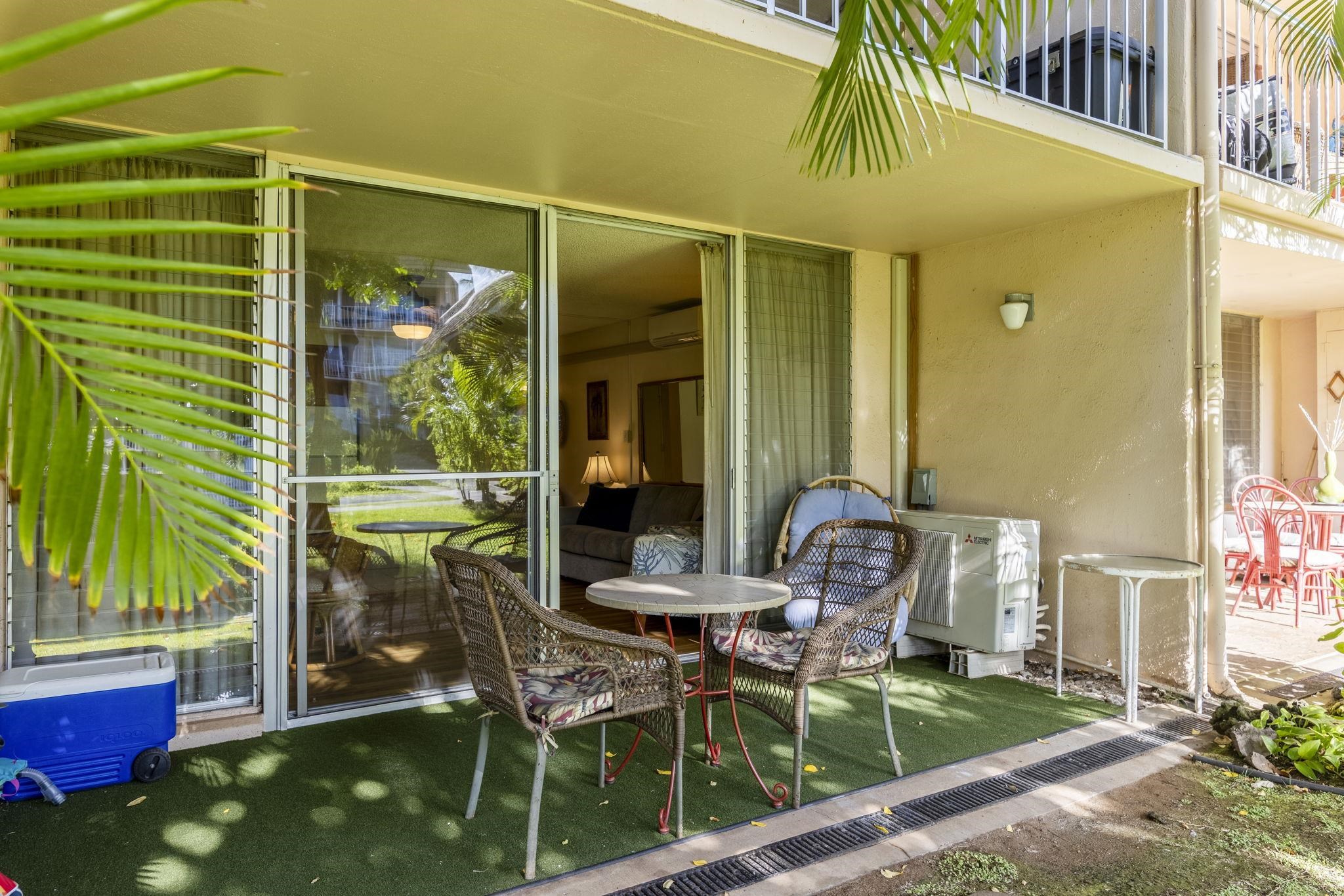 2495 South Kihei Road, Unit 120 Kihei, HI 96753 - Photo 24 of 40 a patio with table and chairs and potted plants