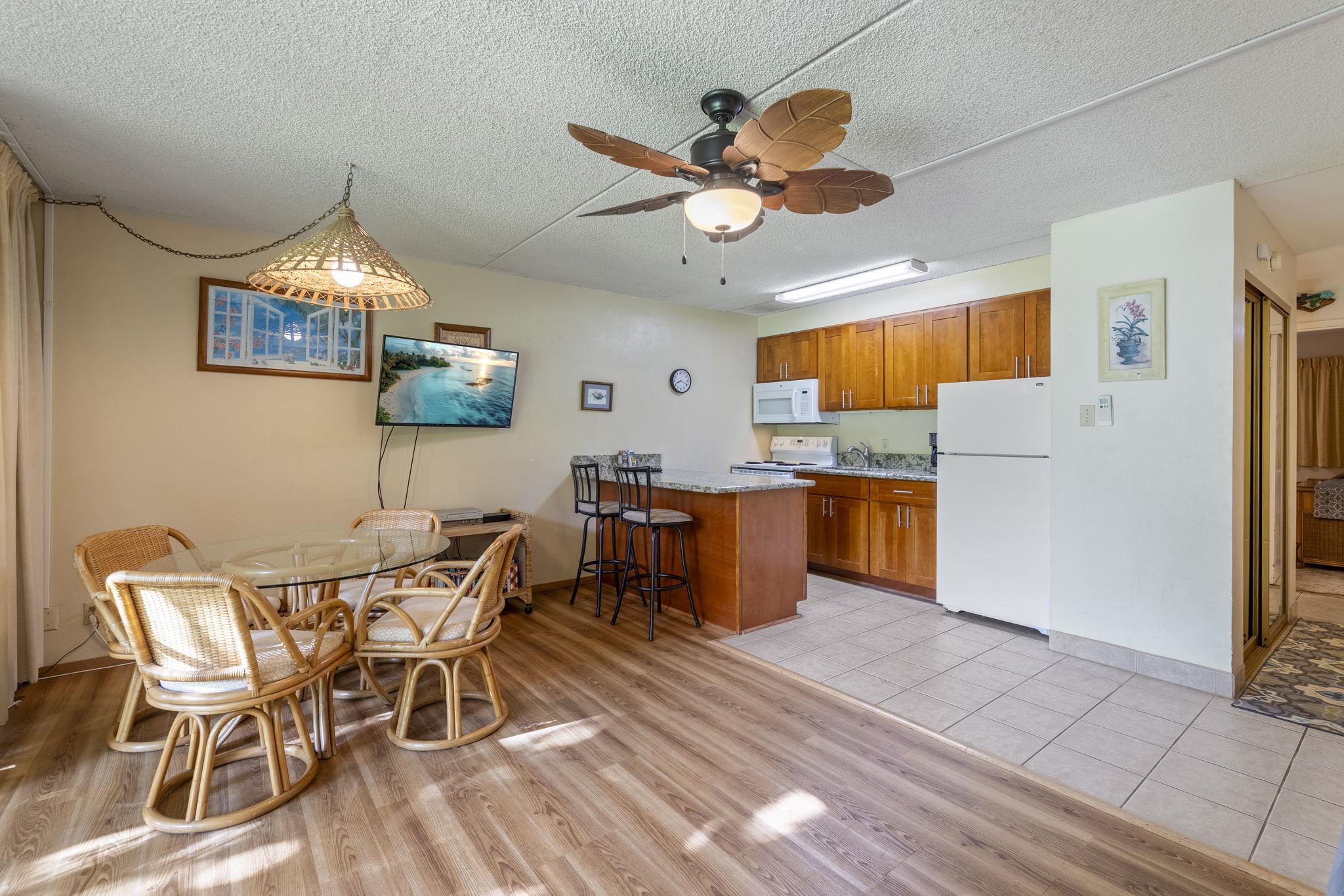 2495 South Kihei Road, Unit 120 Kihei, HI 96753 - Photo 4 of 40 a view of a dining room with furniture window and wooden floor
