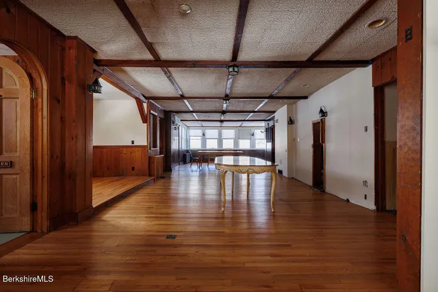 a view of an empty room with wooden floor