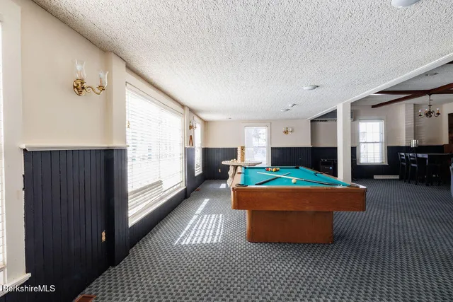 a aerial view of a house with a yard table and chairs