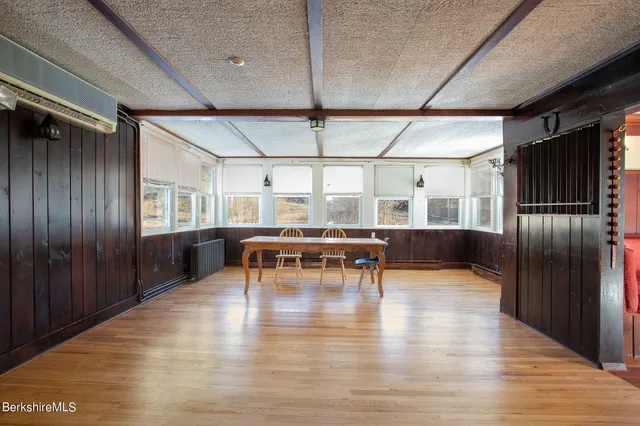 a view of a livingroom with furniture wooden floor and window