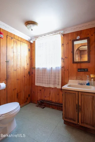 a front view of residential houses with yard and trees